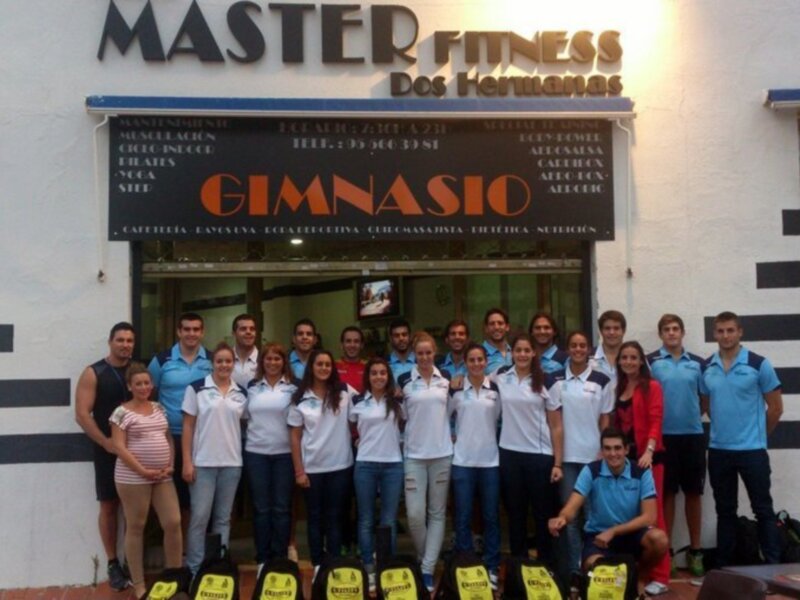 Gruppo de personas posando frente a la entrada de Master Fitness Gimnasio.