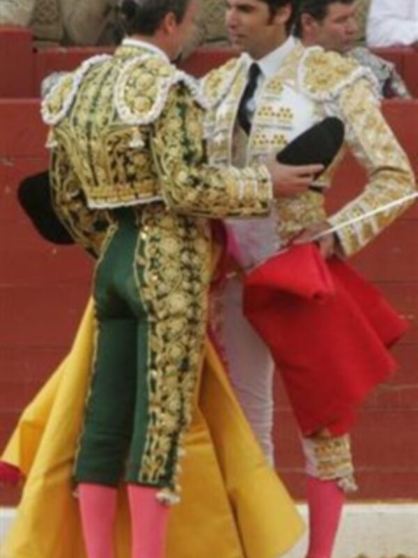 Dos toreros en el ring, uno con traje tradicional y otro con chaleco blanco.
