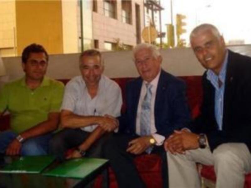 Tres personas sentadas en una sala de espera, posando para una foto.