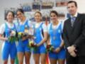 Equipo deportivo celebrando con flores y medallas en un evento formal.