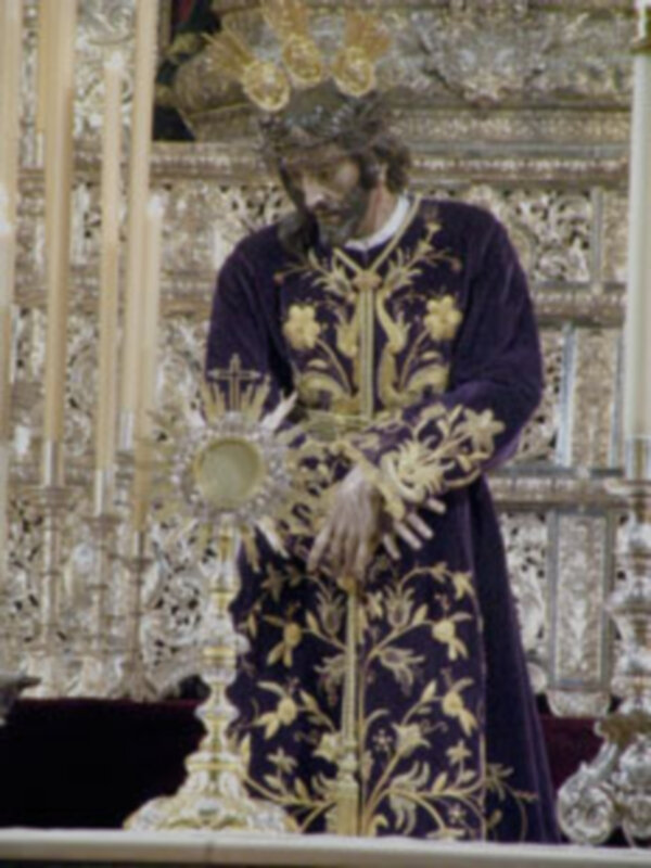 El rey Jorge III de Dinamarca, vestido con un manto ornado y coronado, posa ante una arquitectura elaborada.