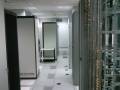 Interior view of a modern server room with rows of server racks and neatly arranged equipment.