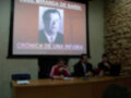 Presentación sobre "Crónica de una Infamia" por Gerardo Miranda de Sardi, con un hombre en la pantalla.