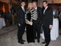 Una familia elegante en un evento formal, posando con elegancia y estilo.