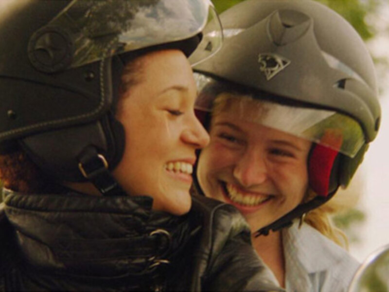 Dos personas sonrientes con cascos de seguridad, posiblemente en un entorno de montaña o deportes extremos.