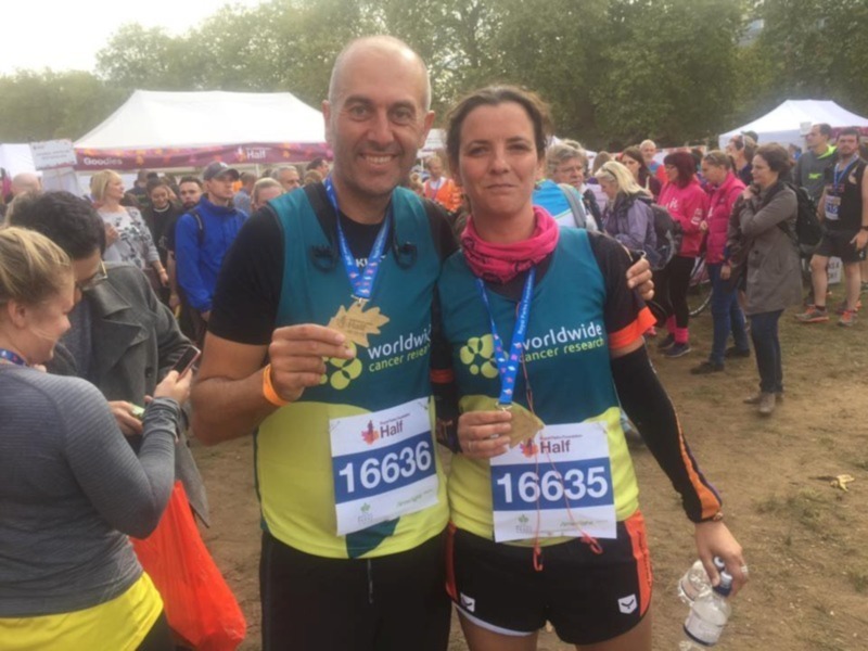 Amateur runners celebrate their medals at the finish line of a charity race.
