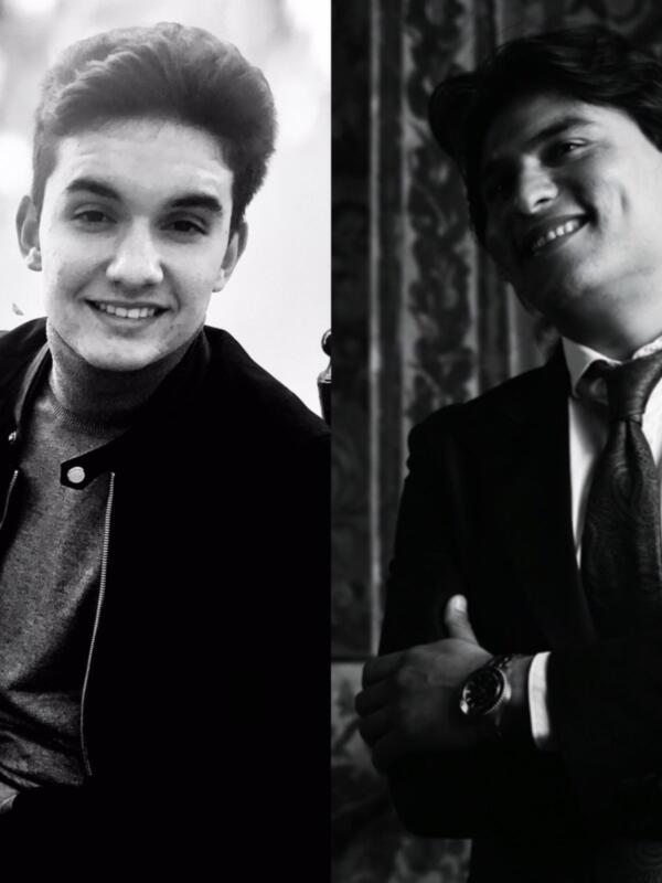 Dos hombres en diferentes estilos de vestimenta, uno con una chaqueta negra y el otro con un traje formal.