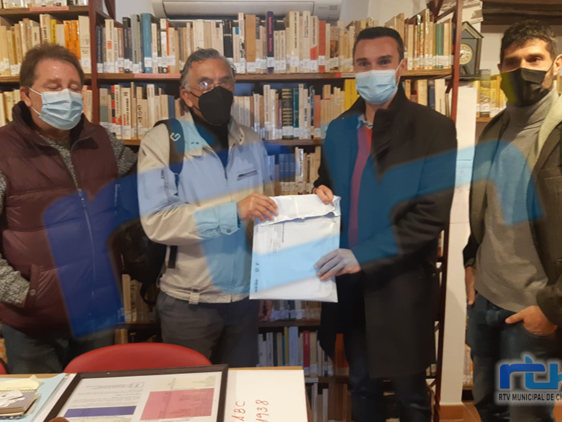 Reunión en una librería, personas intercambiando documentos.