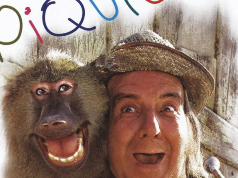 Personaje con sombrero y mono sonrientes, con el título 'Pique' en la parte superior.